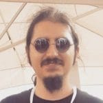 A man wearing sunglasses and a black shirt.