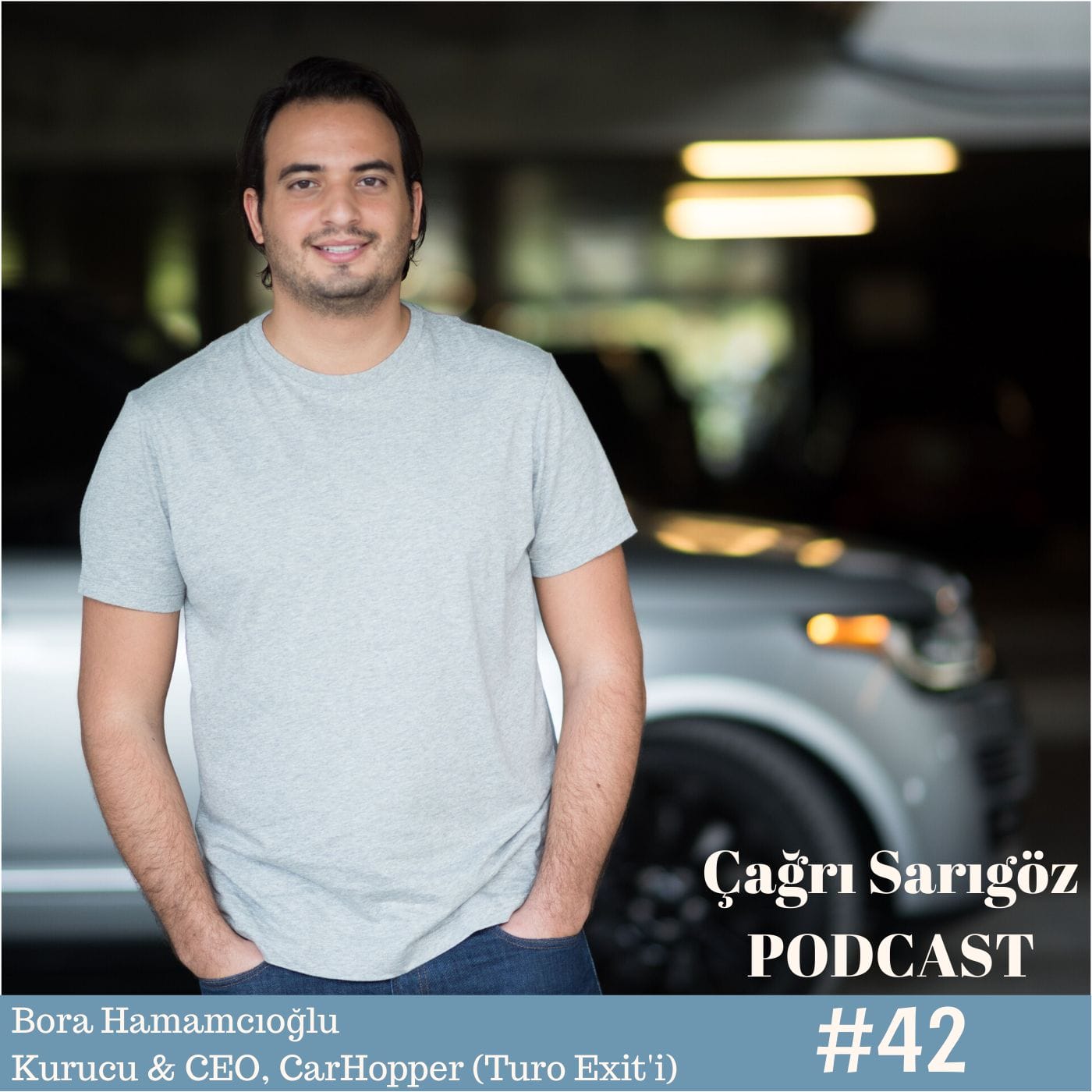 A man standing in front of a car.