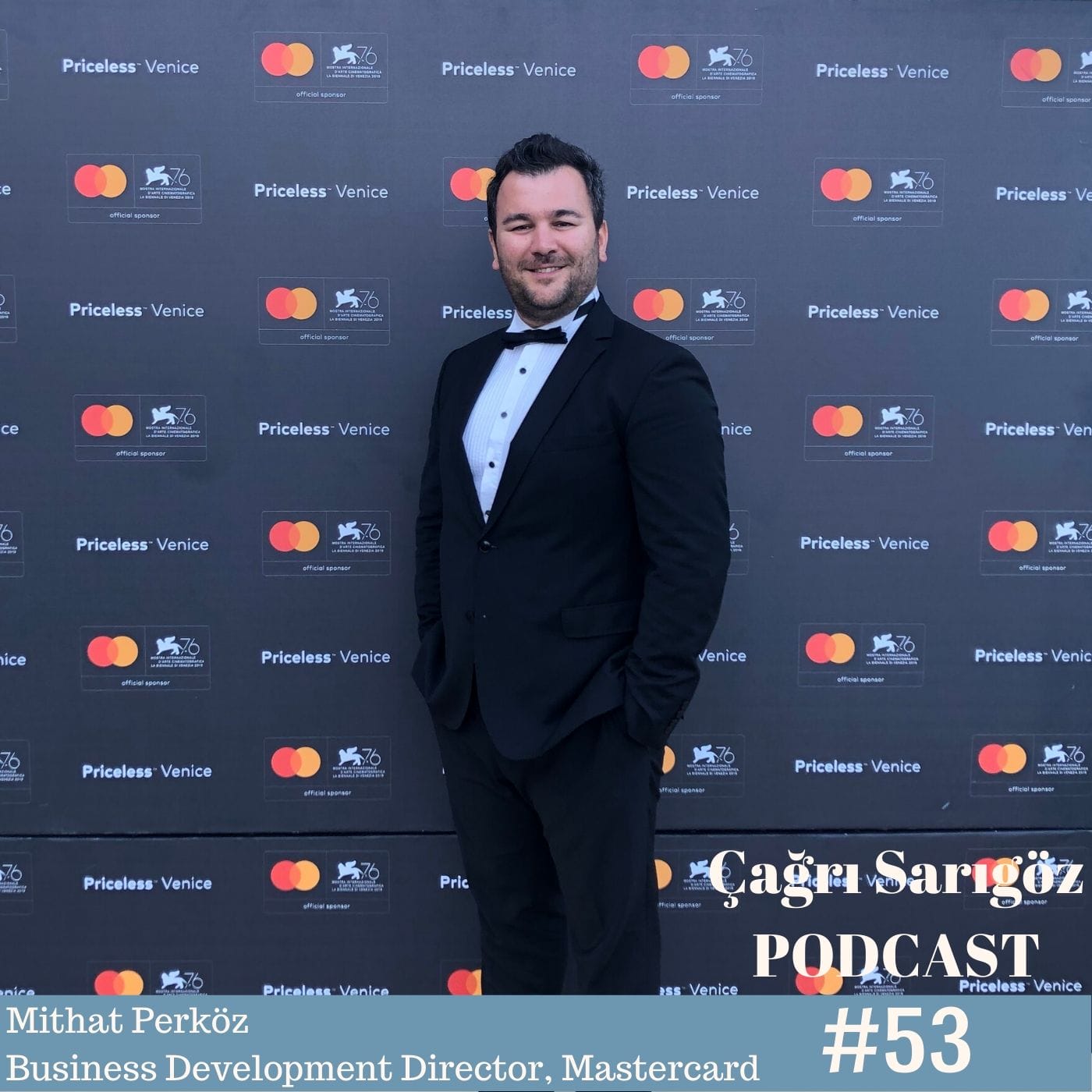A man in a tuxedo standing in front of a red carpet.