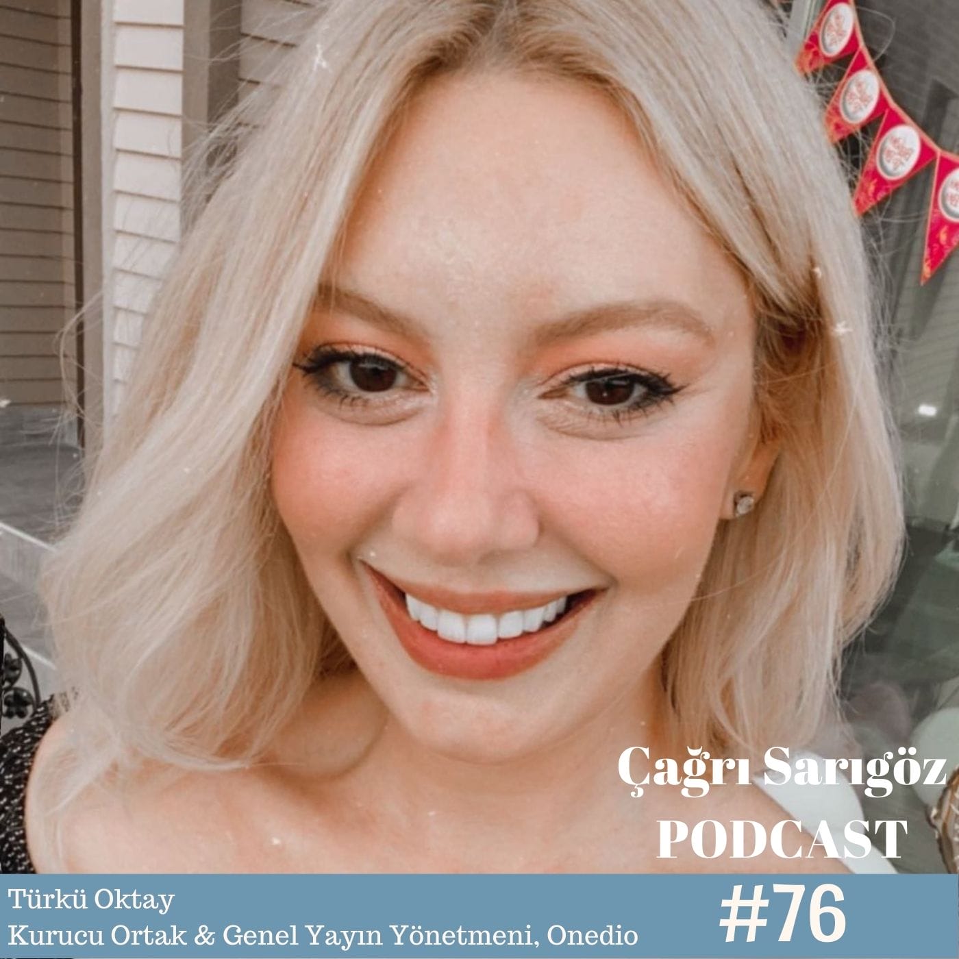 A woman with blond hair and a smile on her face.